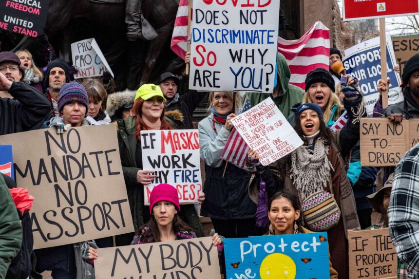 Anti-Vax Activists Hold Rally at Site of Recent Tragedy Involving Gunman and Officer